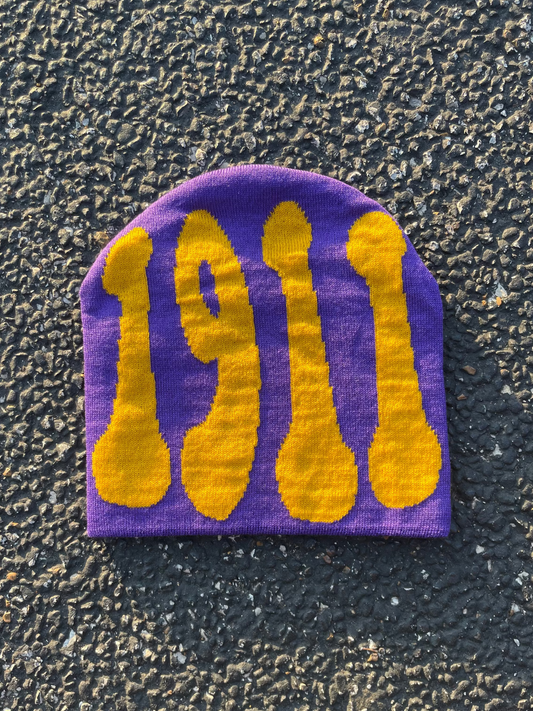 Purple and yellow patch with '1911' design on a textured surface