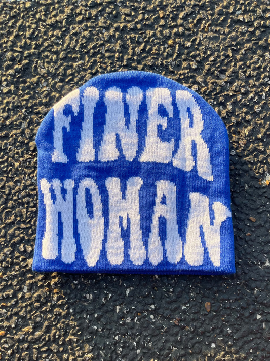 Blue patch with white text 'FINER WOMAN' on a textured black background